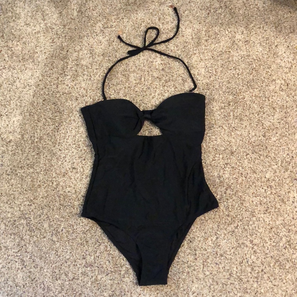 Black one piece with tie and cutout in front.